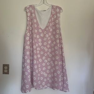 Lavender and daisy print, sleeveless, a frame, dress hits just above the knee.